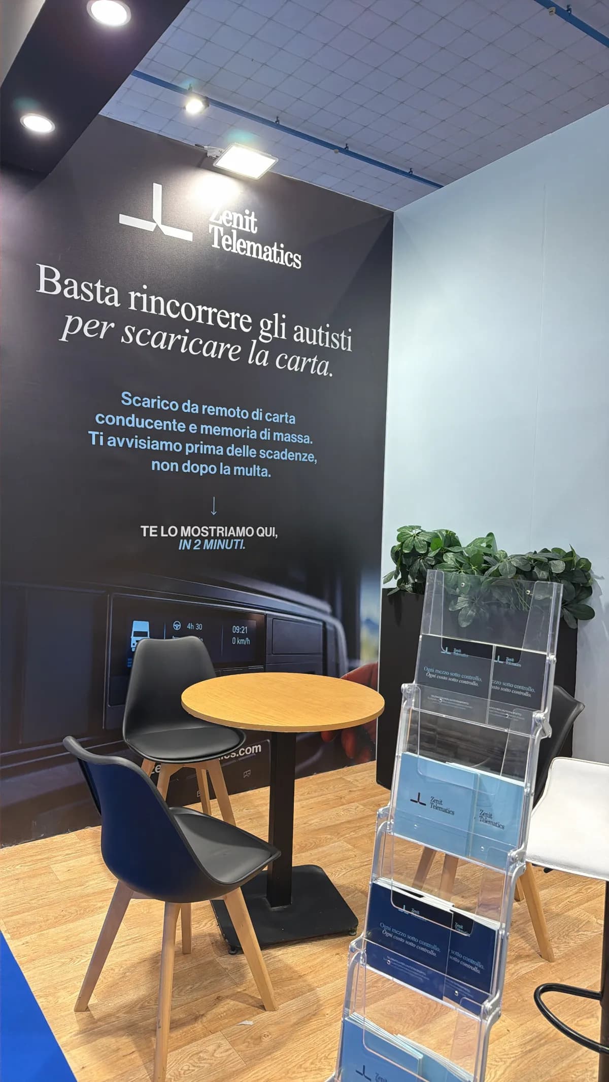 The meeting area of the Zenit stand, with a table, seating and the panel on remote driver card downloads